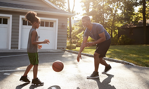 Father playing basketball with his daughter