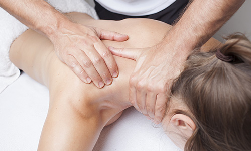 Woman getting a trigger point massage focused on her neck
