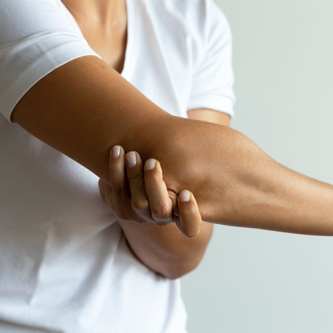 Man holding his elbow in apparent pain