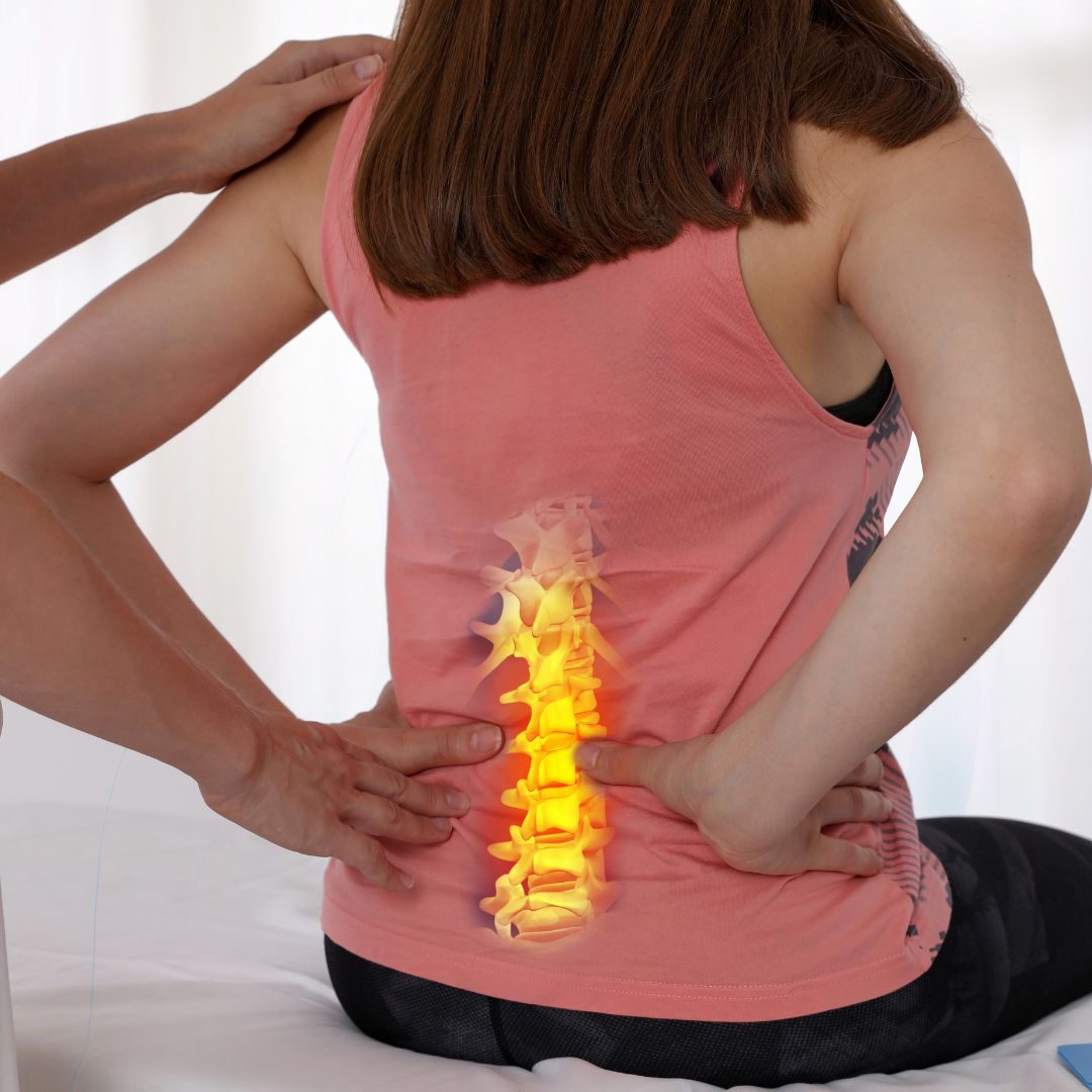 Woman showing spine in pain