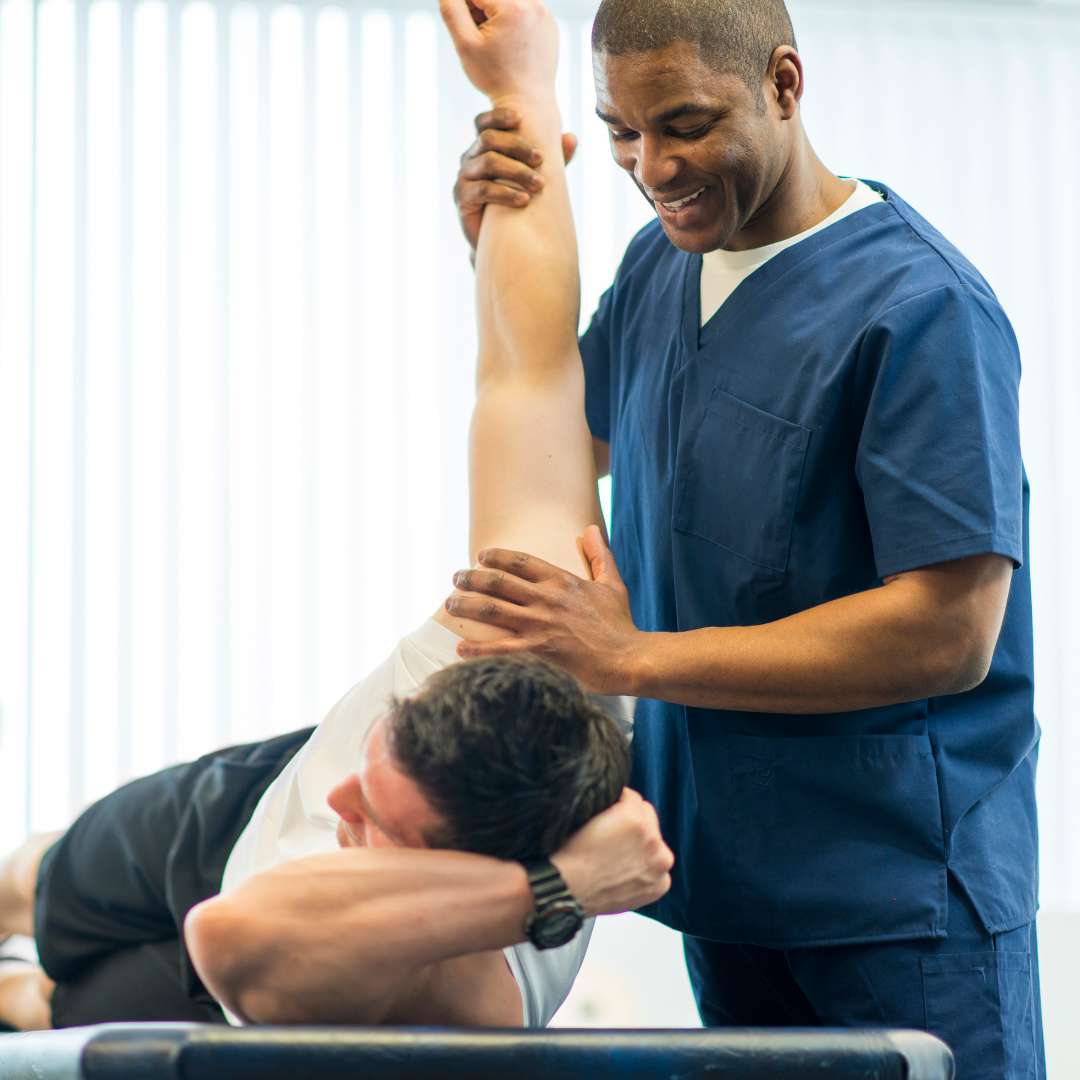physical therapist stretching out patient