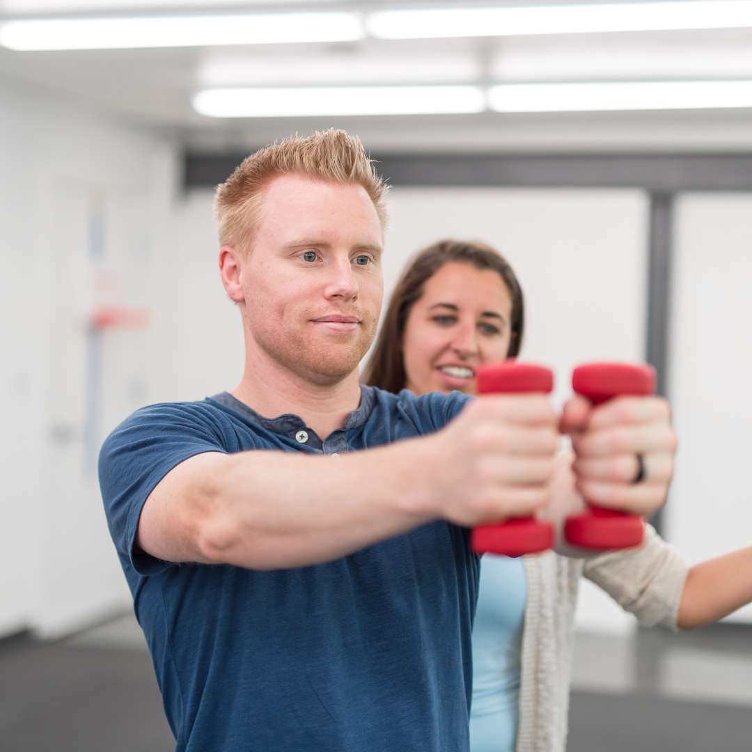 physical therapy patient working with dumbbells