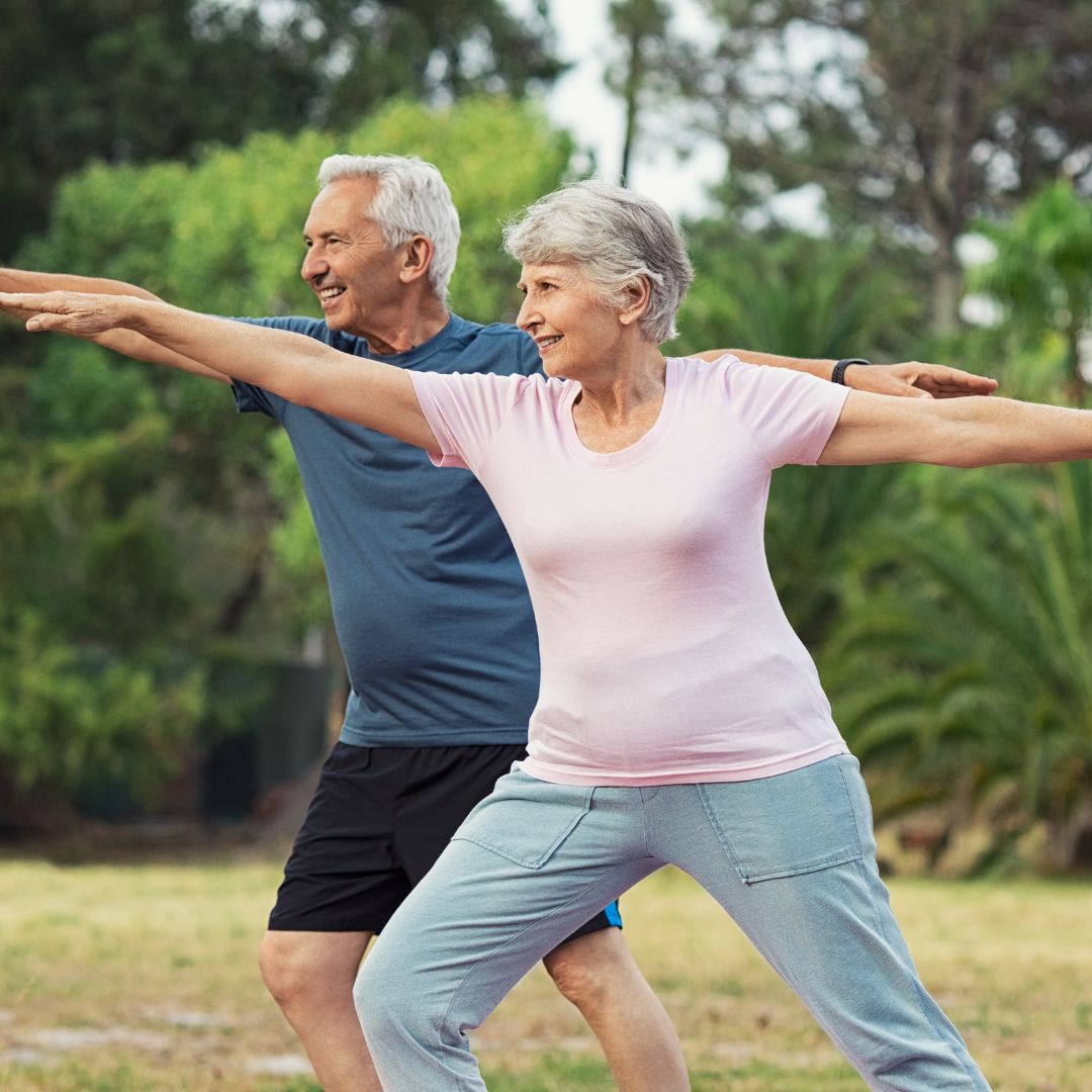 Two older people doing yoga poses