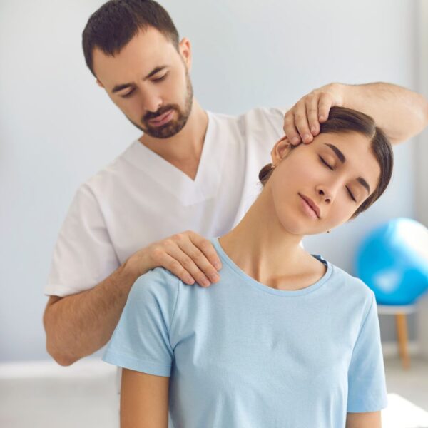 chiropractor cracking woman's neck