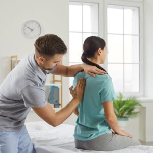 chiropractor working with patient