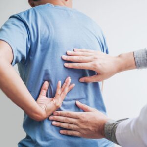 physical therapist working on a man's back