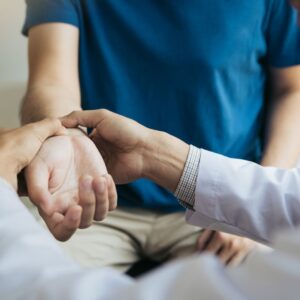 physical therapist working on someone's wrist