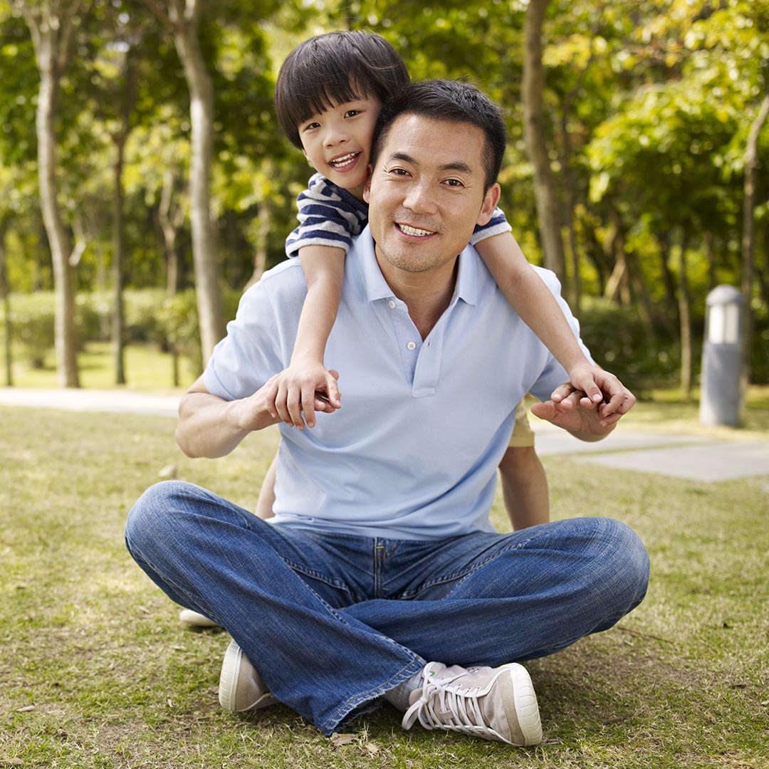 smile father with his son on his back