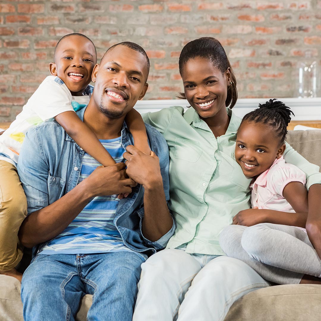 happy family sitting on their couch