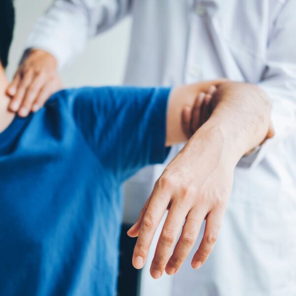 physical therapist stretching arm