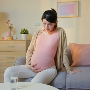 pregnant woman looking uncomfortable.