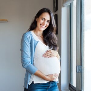 pregnant woman cradling her belly.