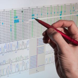 Someone marking a paper copy of DNA sequences