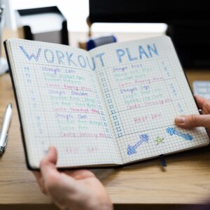 A notebook reading "Workout Plan" with lots of notes