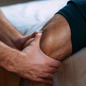Close-up of a muscular, athletic leg being massaged