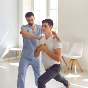 Patient performs lunges with therapist's assistance