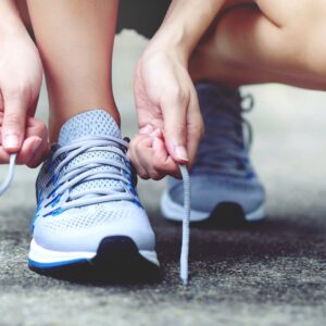 img of someone tying their shoes