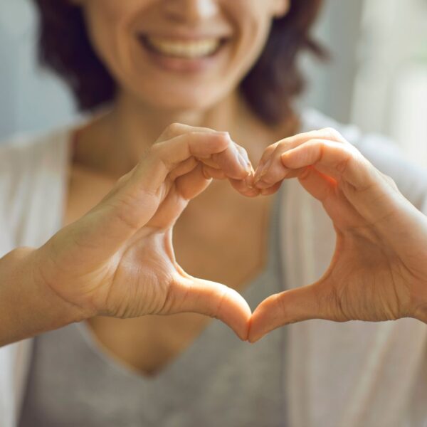 healthy person forming heart with hands