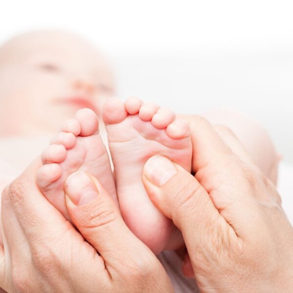 a baby having their feet adjusted