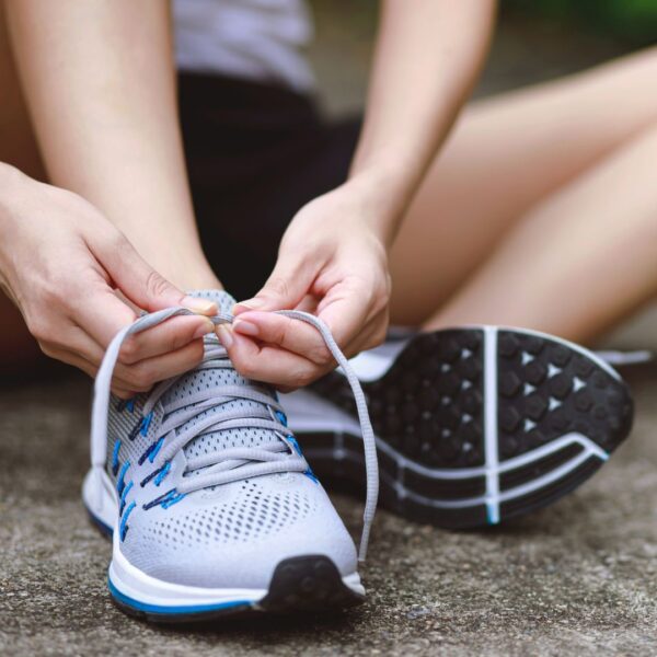 a woman tying a shoe