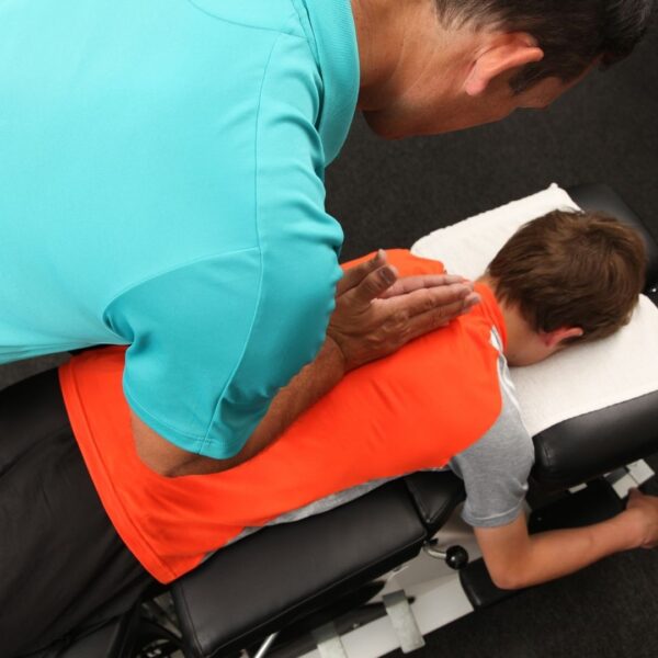 chiropractor adjusting a child's spine